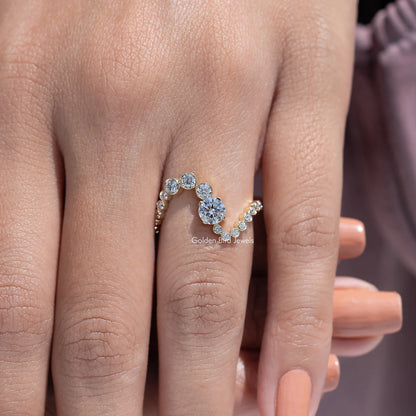 Gold wave wedding band with alternating round stones, detailed close-up on hand