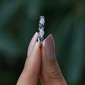 Side View of Round And Marquise Cut Moissanite Band In two fingers