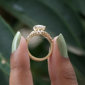 Back View of Round Cut Moissanite Accent Stone Ring In two fingers