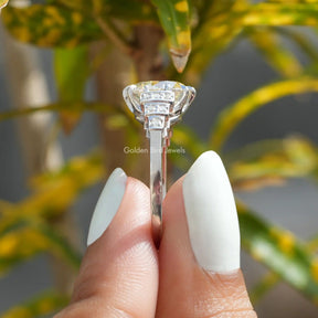 Side View of Round Cut Accent Stone Ring In two fingers