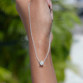 In hand showing view of diamond pendant