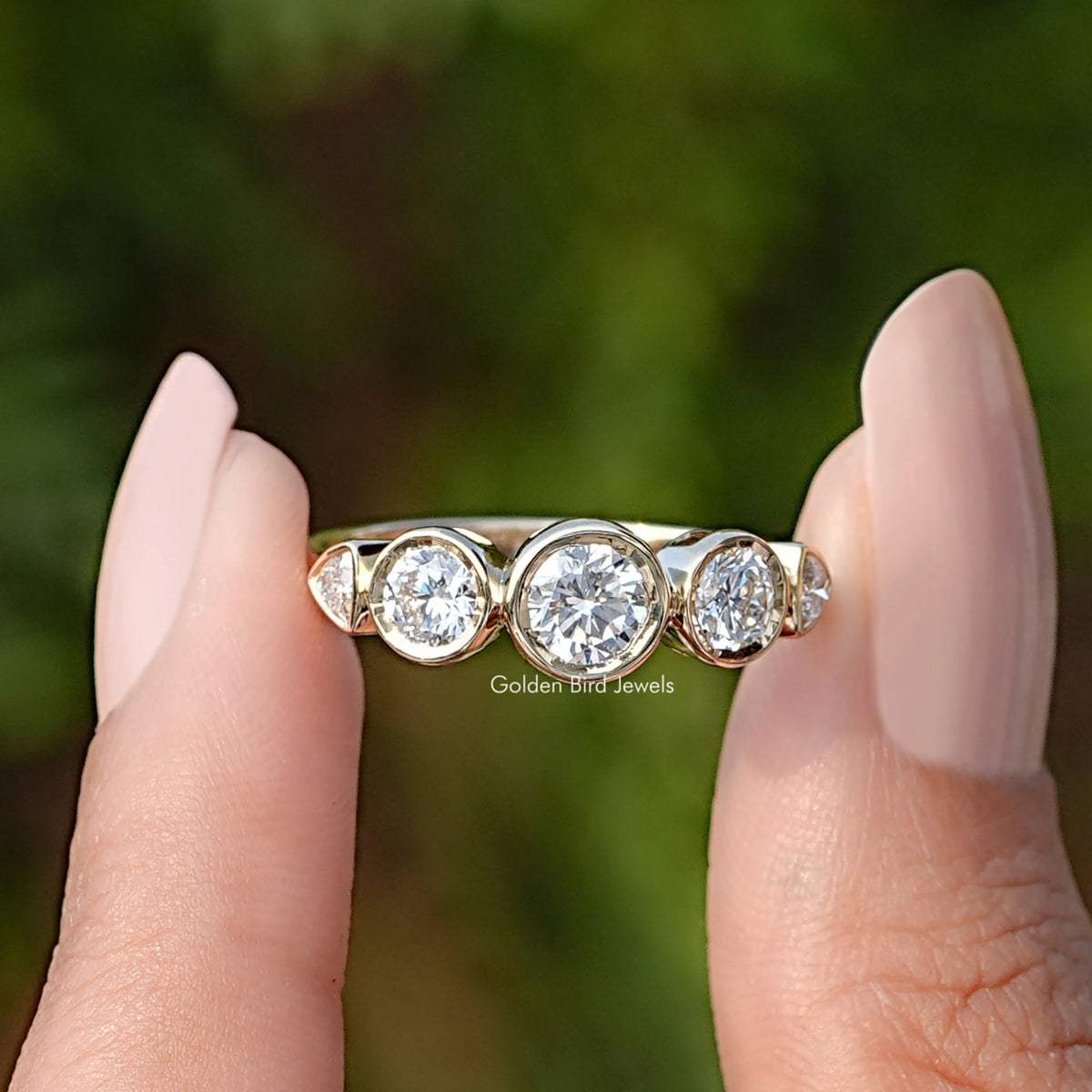 Front View of Round Cut Lab Diamond Five Stone Bezel Set Ring In two Fingers