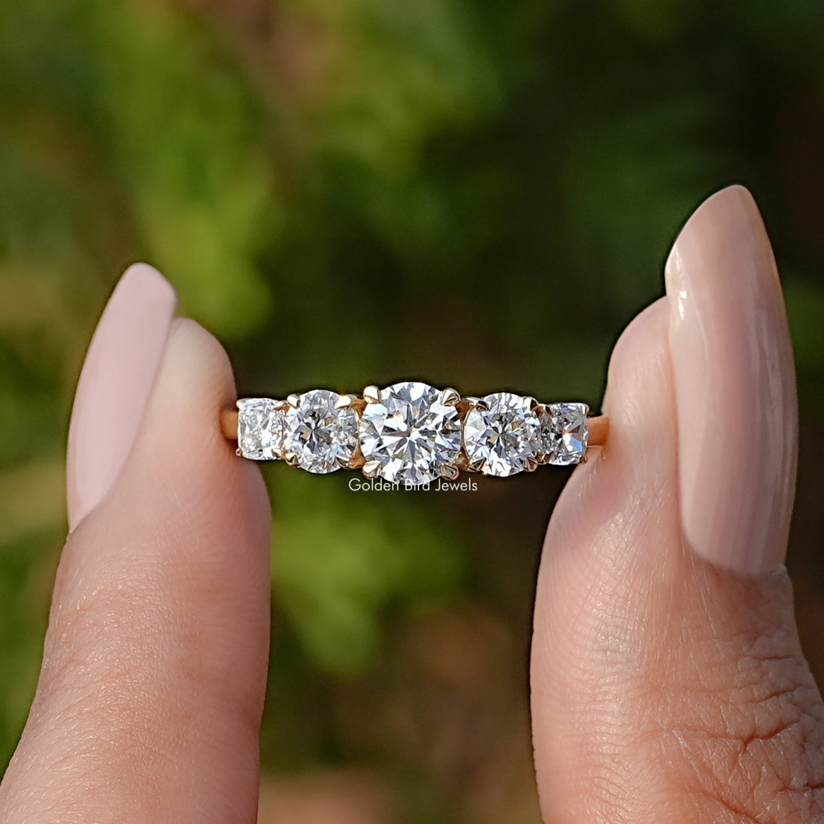 Front View of Round Cut Lab Diamond Five Stone Ring In two Fingers