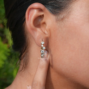 Ear's View of Round Cut Diamond Bezel Set Hoop Earrings In Yellow Gold