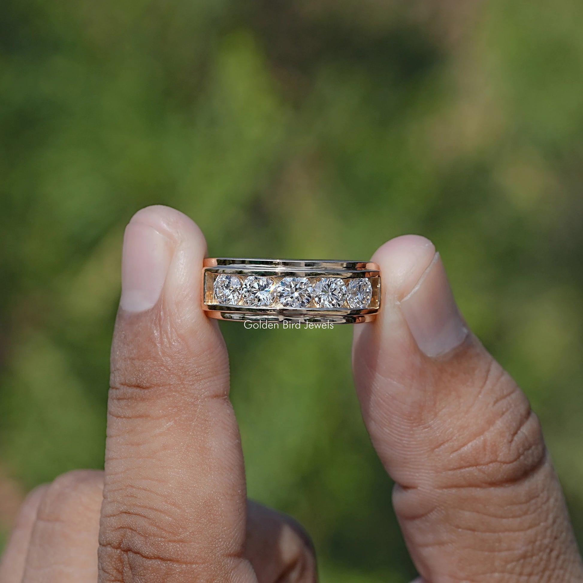 Front view of Lab Diamond Channel Set Men's Ring holding in two fingers 
