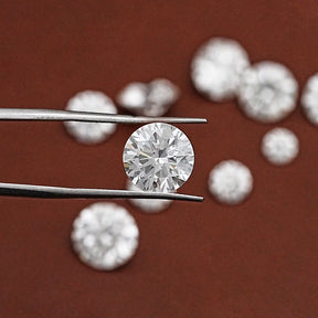 Tweezer holding On the Round Cut Loose Lab Grown Diamond