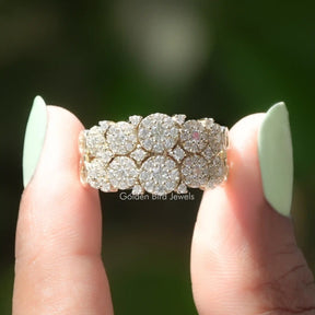 Two fingers holding the Round Cut Moissanite Cluster Engagement Ring