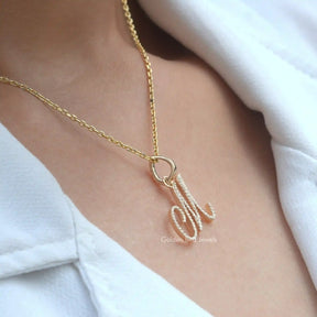 In neck side view of round cut moissanite letter pendant