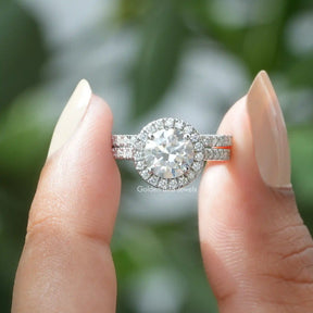 Two fingers holding the Round Cut Moissanite Halo Wedding Ring 