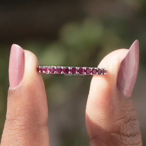 Front View of Round Cut Pink Tourmaline Gemstone Eternity Band In two Fingers