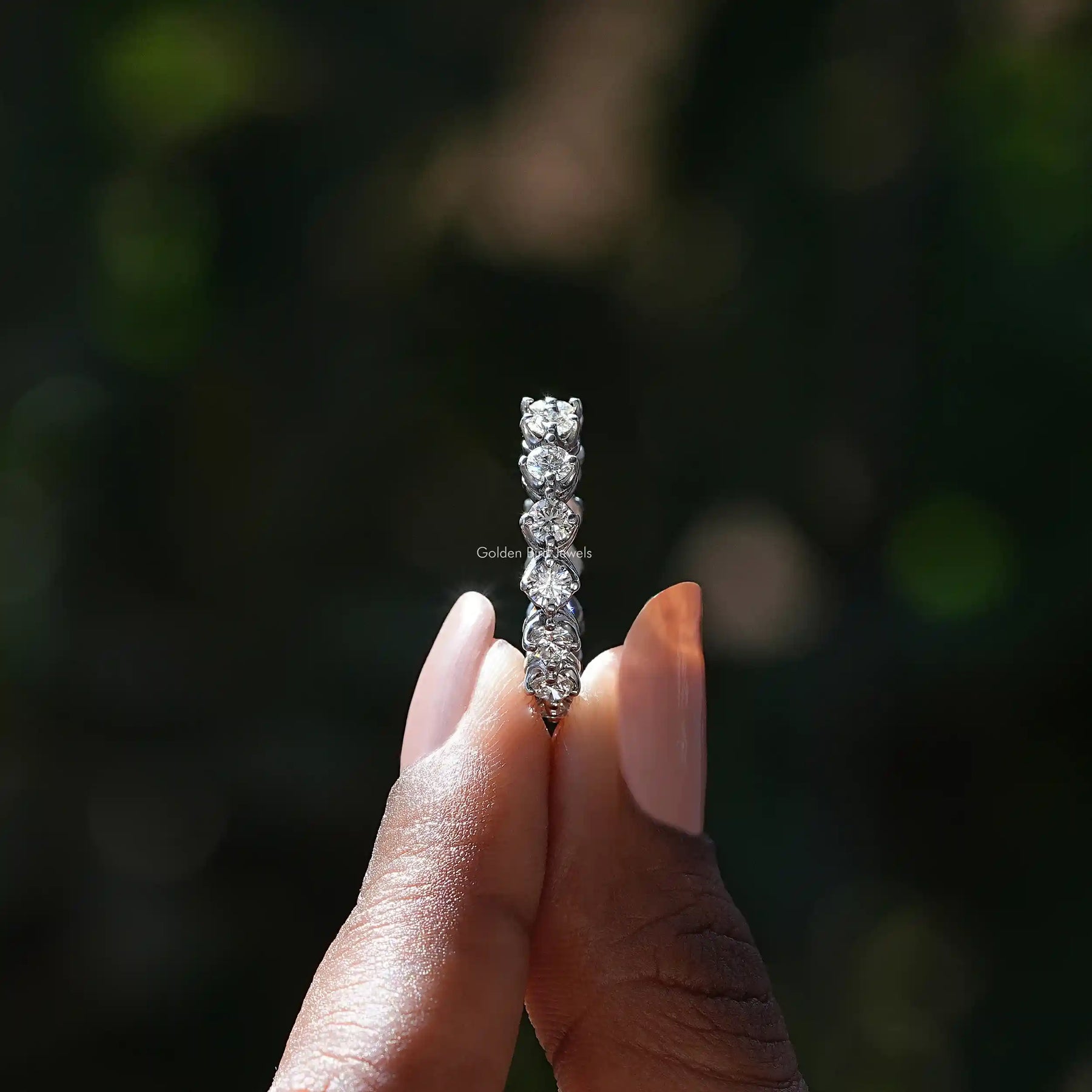 Side View of Round Cut Diamond Eternity Wedding Band In two fingers