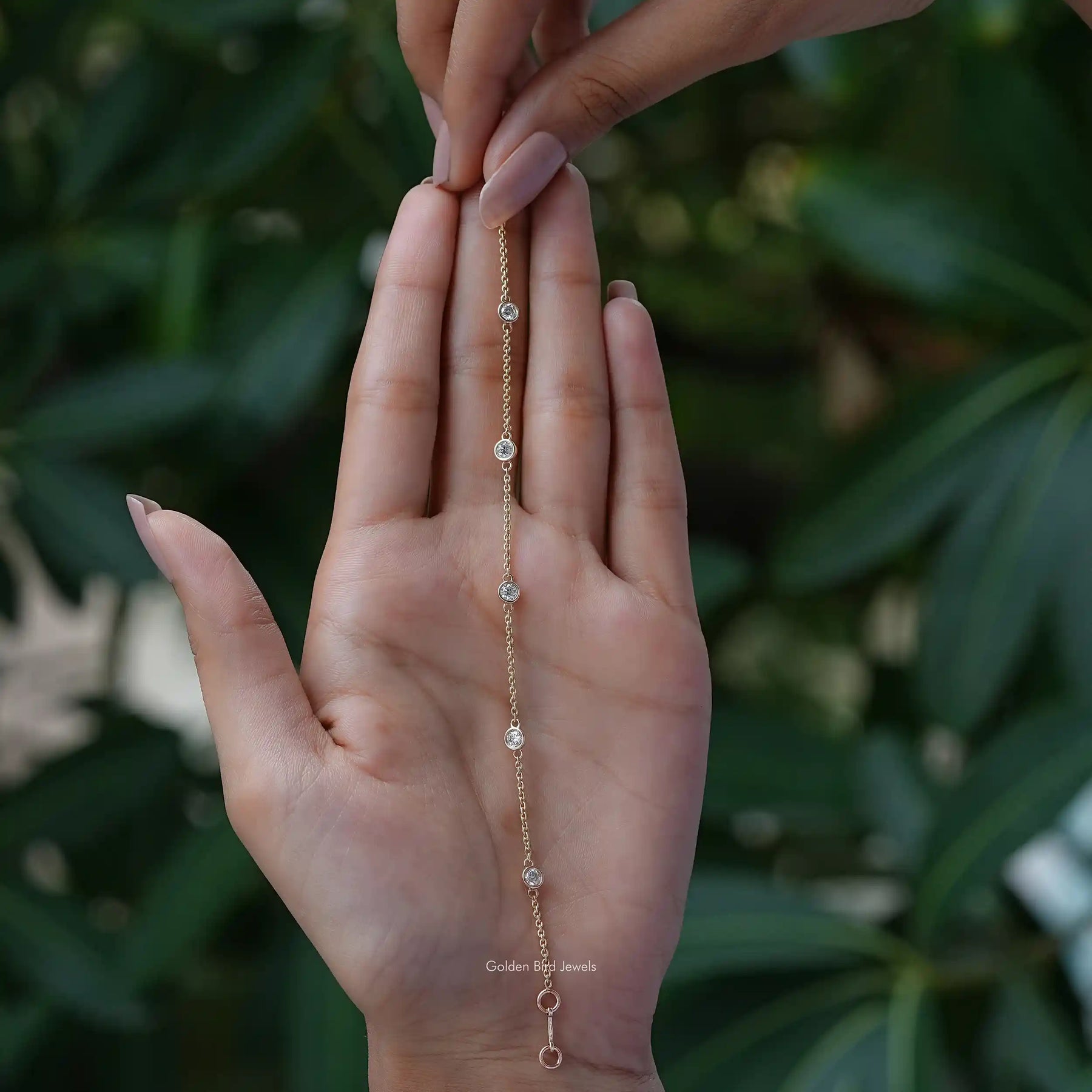 In hand showing view of moissanite bracelet