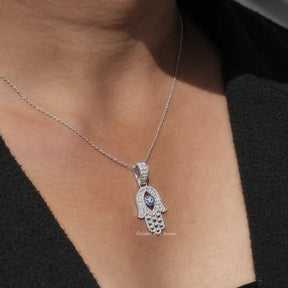 In neck view of hamsa hand moissanite halo pendant in white gold