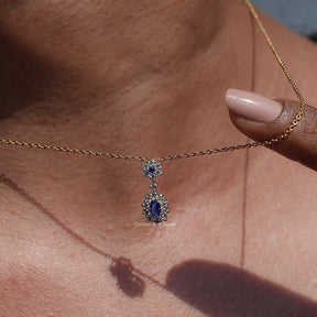 wear in women's Sapphire Blue Oval Cut Gemstone Halo Pendant 
