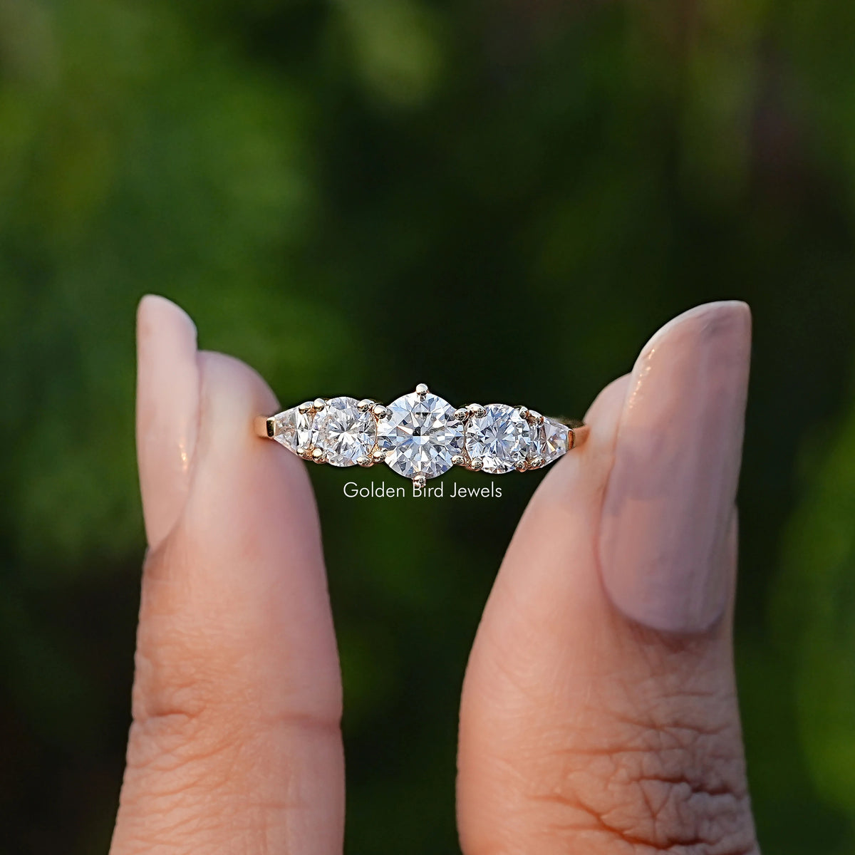 Front View of Shield And Round Lab Diamond Five Stone Ring In two Fingers