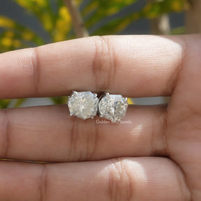 Shield Stud moissanite earrings in Holding center of finger 