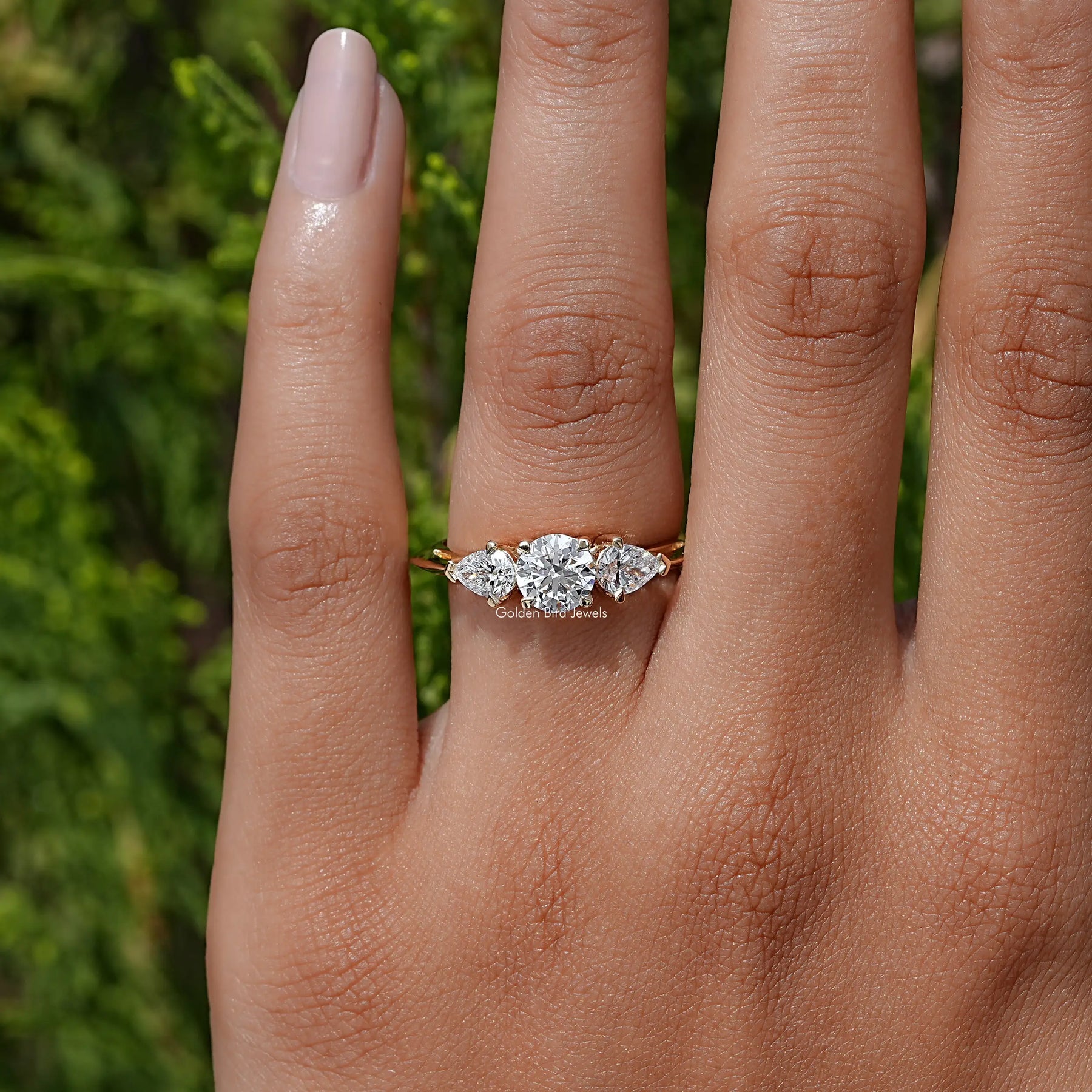 View of Pear And Round Cut Diamond Three Stone Engagement Ring In Yellow Gold