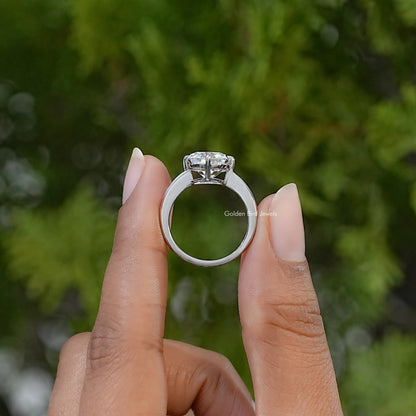 Sterling silver solitaire ring shown from the side, displaying the elevated cushion-cut stone and band.