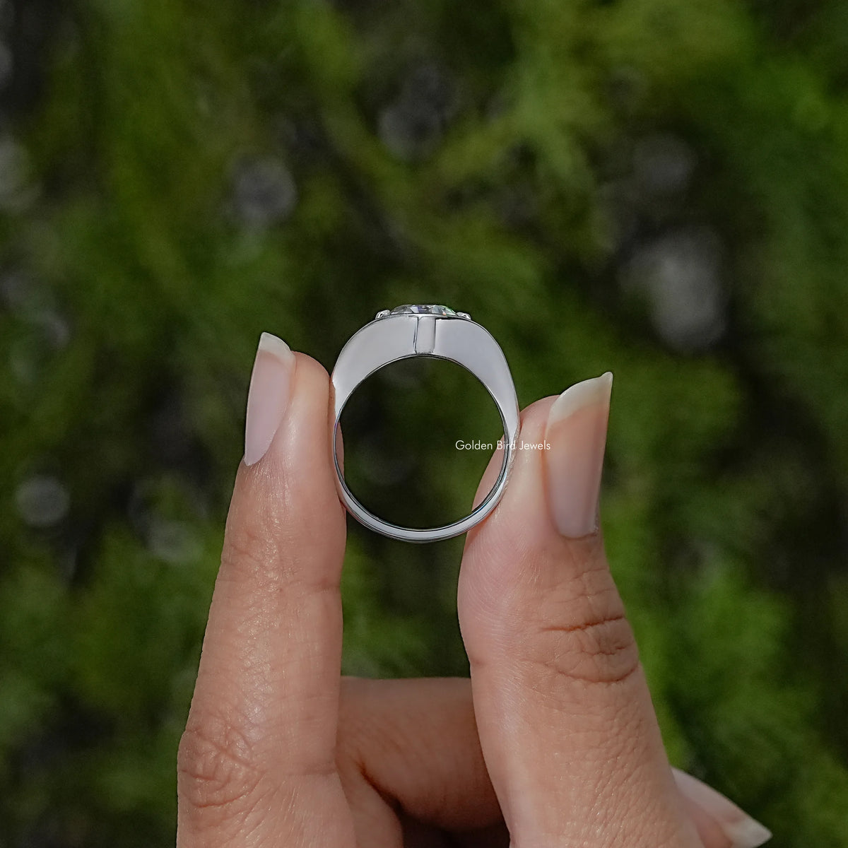 Sterling silver ring viewed from behind, showing its curved band and round solitaire setting
