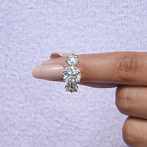 In finger front View of Cushion Cut Diamond Three Stone Ring In Yellow Gold