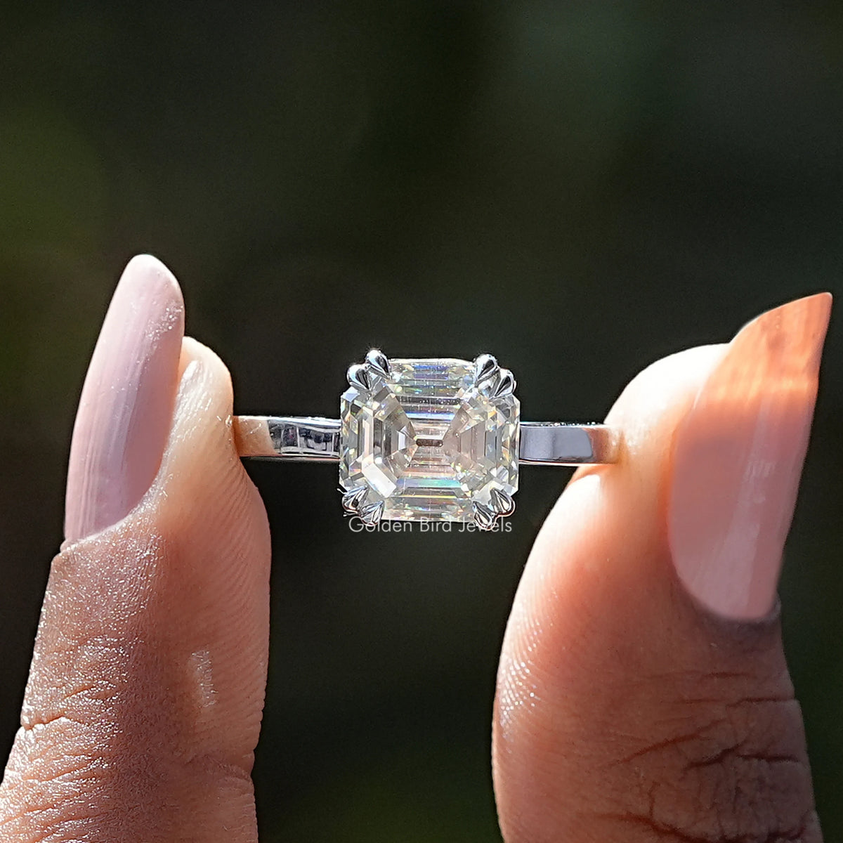 Two fingers holding the Asscher Cut Moissanite Solitaire Ring