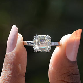 Two fingers holding the Asscher Cut Moissanite Solitaire Ring