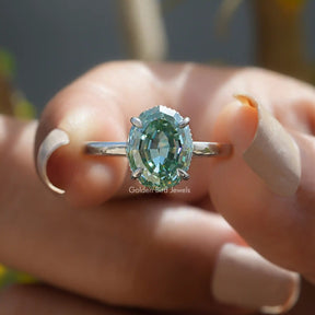 Front View of Blue Step Cut Oval Moissanite Ring In two Fingers