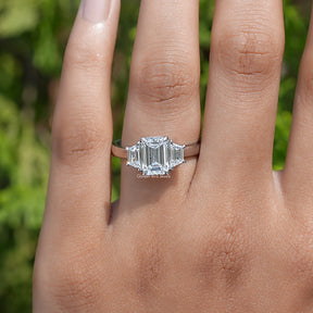View of Emerald Cut Diamond Three Stone Ring In Yellow Gold