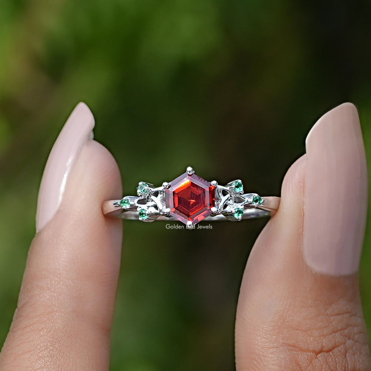Front View of Sunstone Hexagon Cut Gemstone Ring In two Fingers