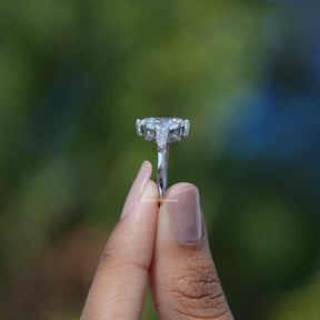 Side View of Baguette Cut Diamond Five Stone Ring In two fingers
