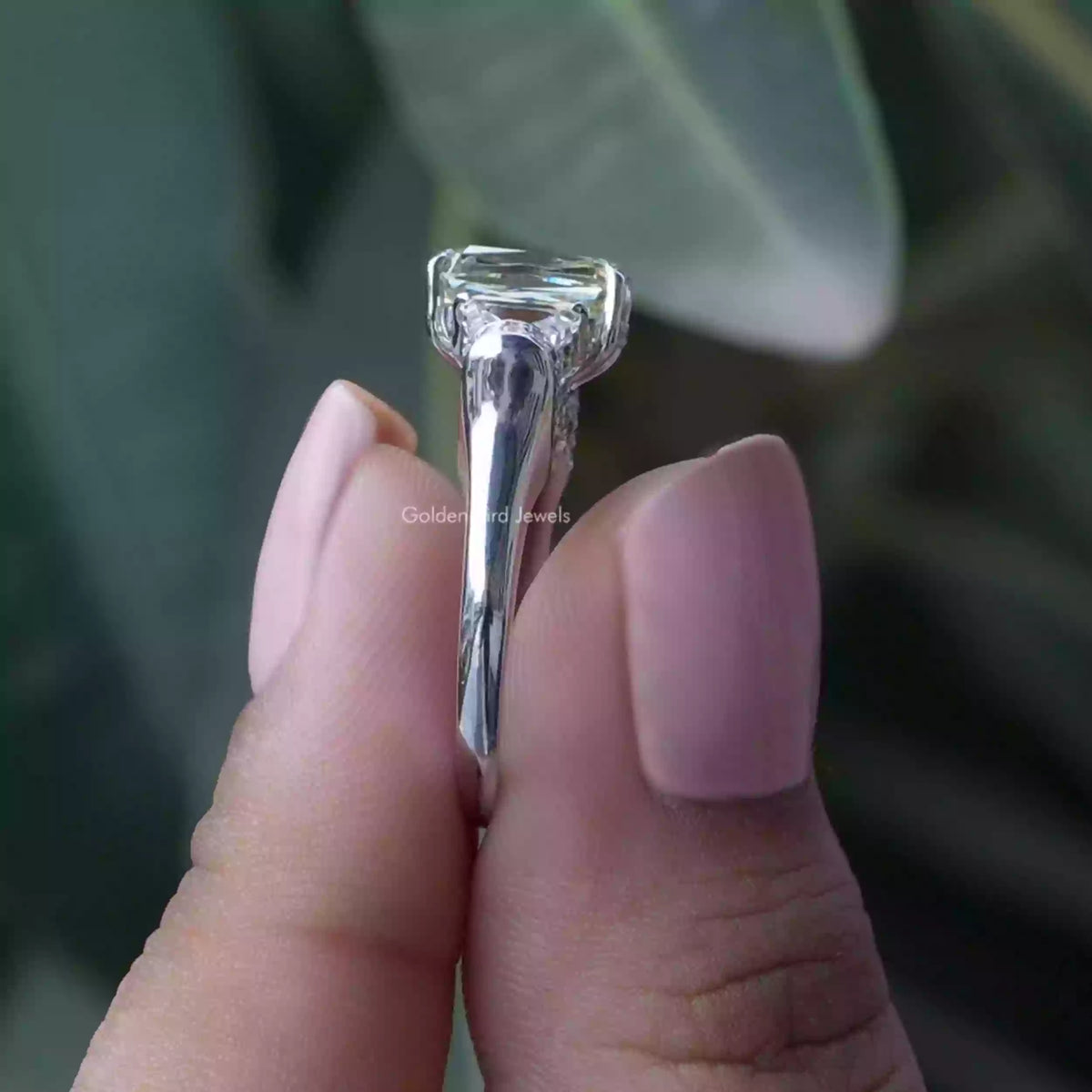 Side View of Criss And Trapezoid  Moissanite Ring In two fingers