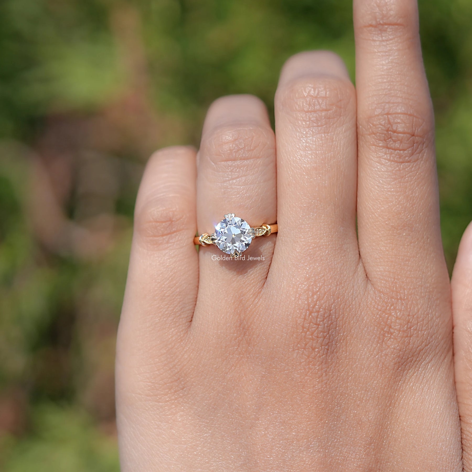 In finger front view of Old European Round Moissanite engagement ring 