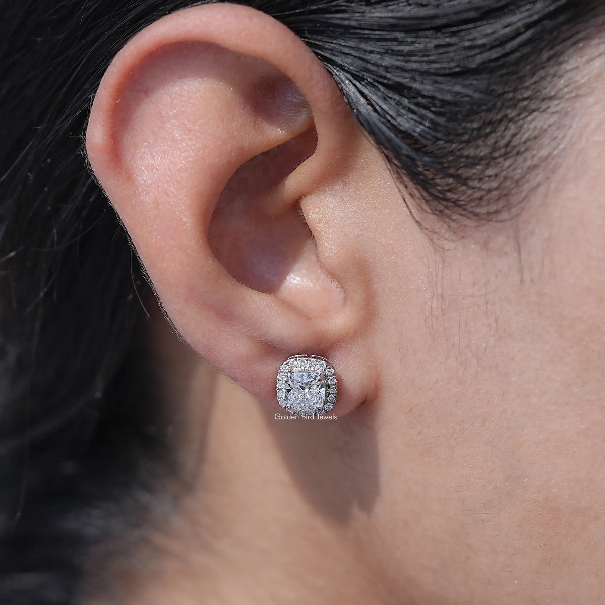 In ear view of cushion cut cluster diamond earrings	In White Gold		