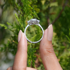 Back View of Emerald Cut Lab Diamond Three Stone Ring In two fingers