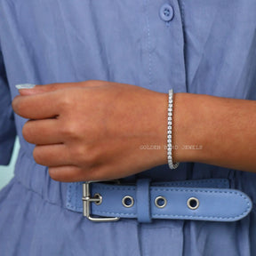 On hand front view of round cut moissanite bracelet made in prong setting 
