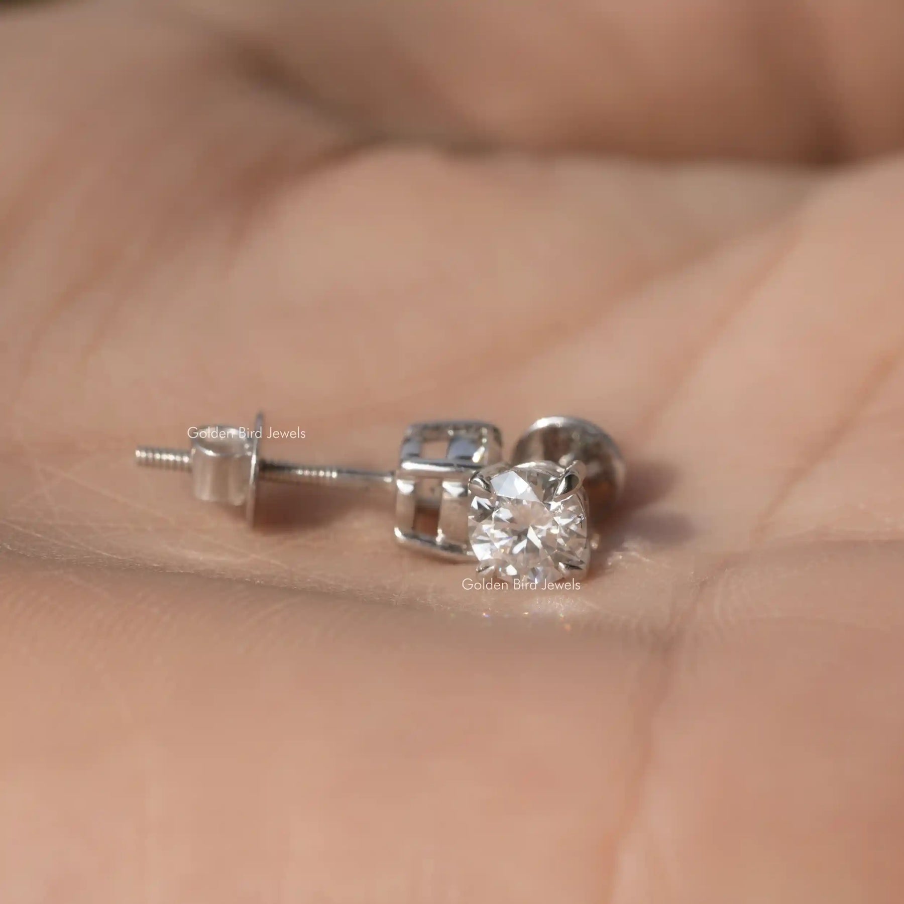 Front and back view of round cut moissanite earrings in prongs setting 
