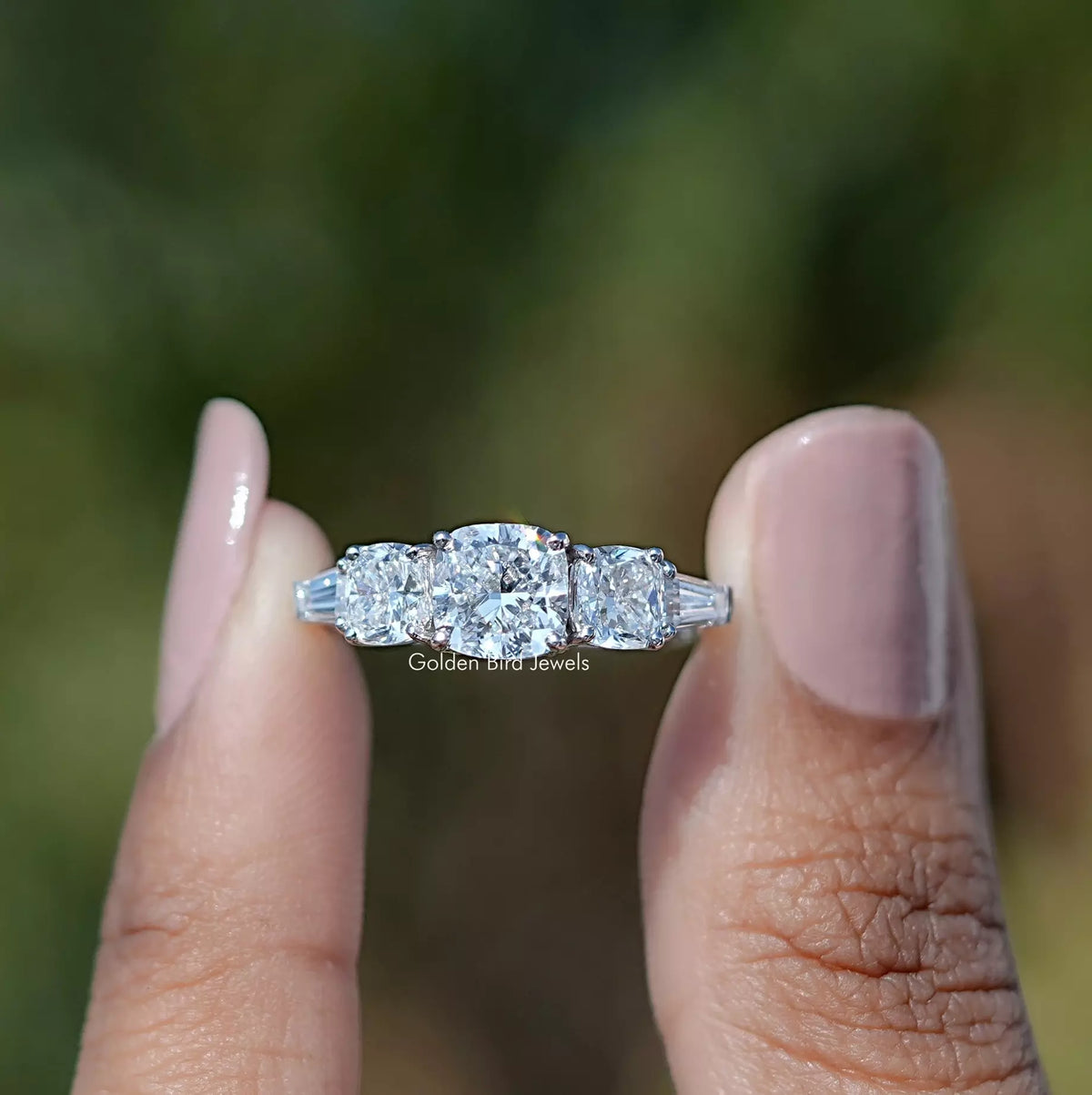 Front View of Cushion And Tapered Baguette Cut Five Stone Ring In two Fingers