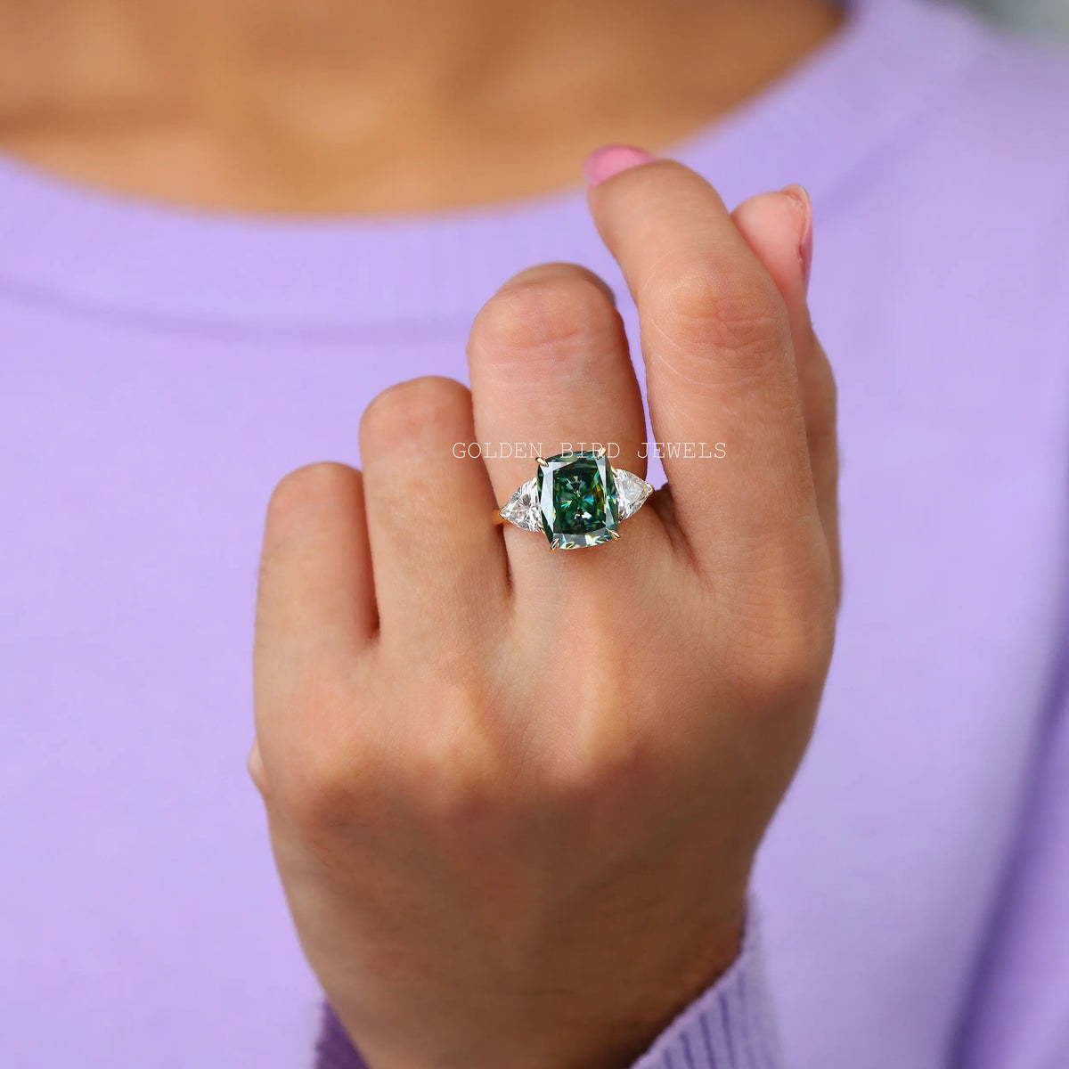 In Finger view of three stone moissanite ring  