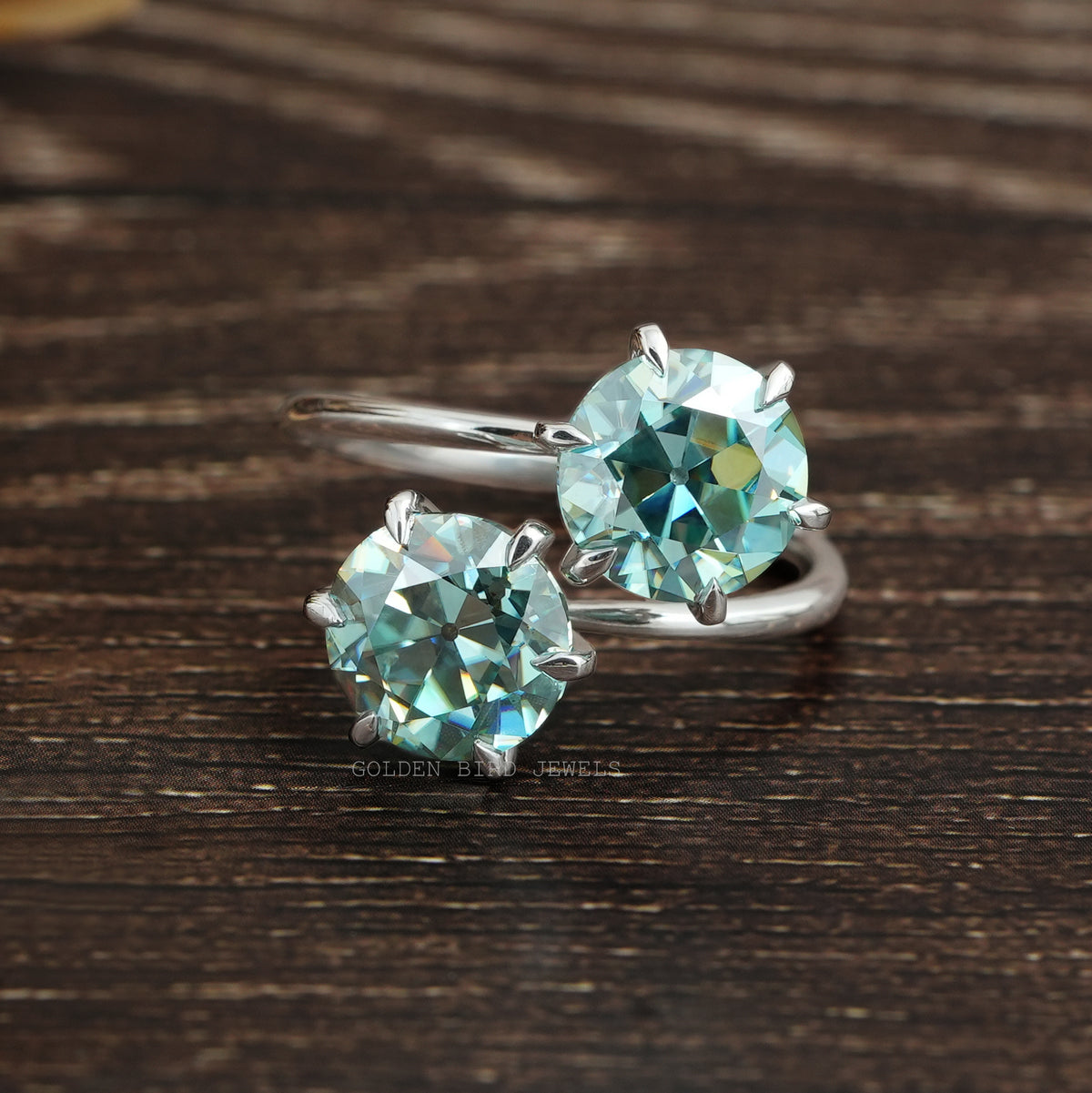 Front view of blue round cut  moissanite  engagement ring  
