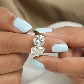 In finger front View of Pear And Round Cut Moissanite Toi Et Moi Ring In White Gold