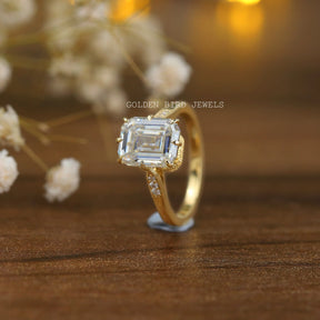 Front View of a emerald cut engagement ring in yellow gold 
