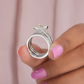 Front View of Emerald Cut Moissanite Engagement Ring In two Fingers