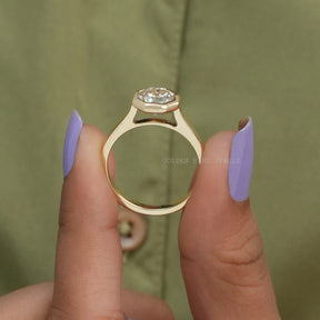 Back View of Cathedral Set Octagon Cut Moissanite Solitaire Ring In two fingers