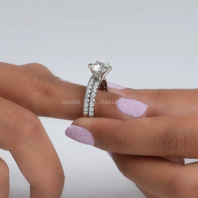 In finger front view of Colorless Round Cut Moissanite Ring Set In White Gold